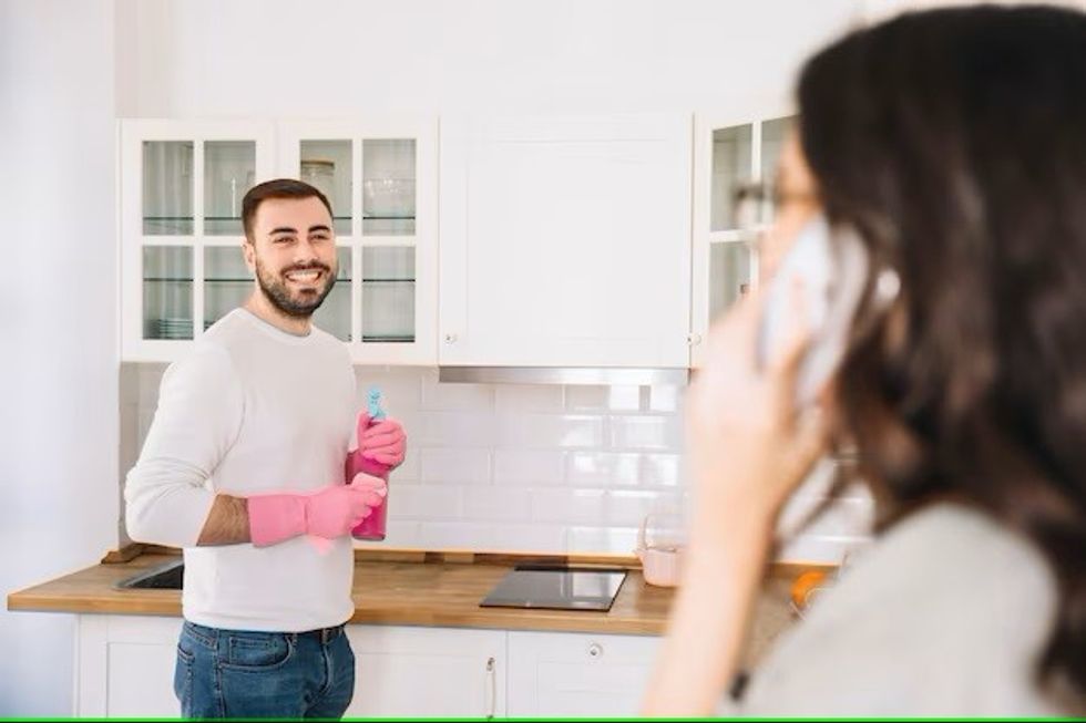 woman talking phone while man cleaning 23 2147766965
