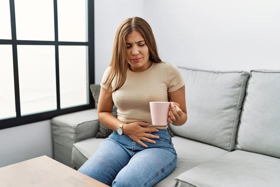 woman upset stomach tea e1661488555881