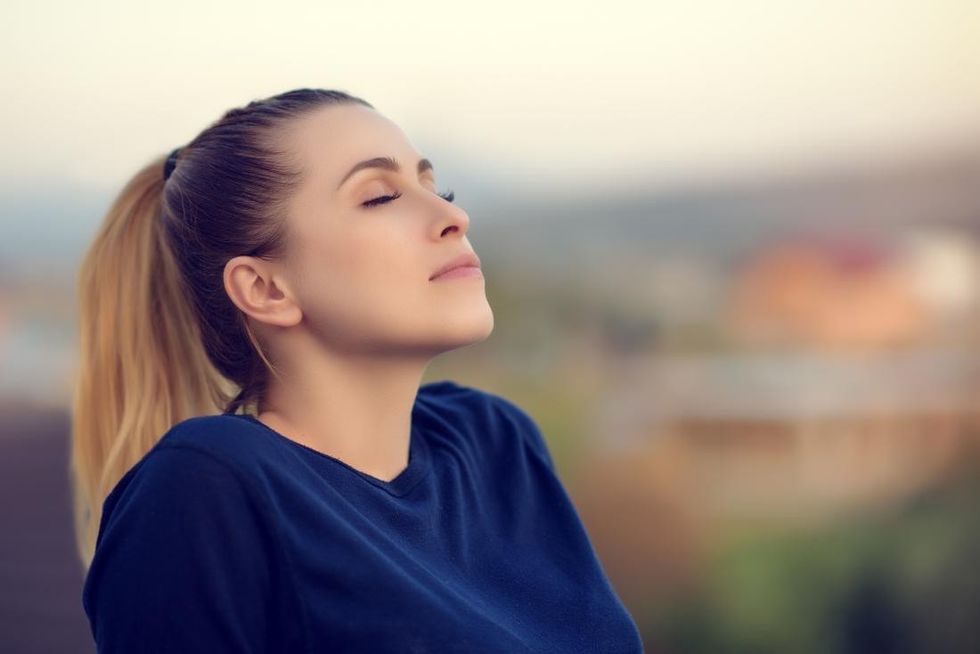 woman with her eyes closed performing box breathing