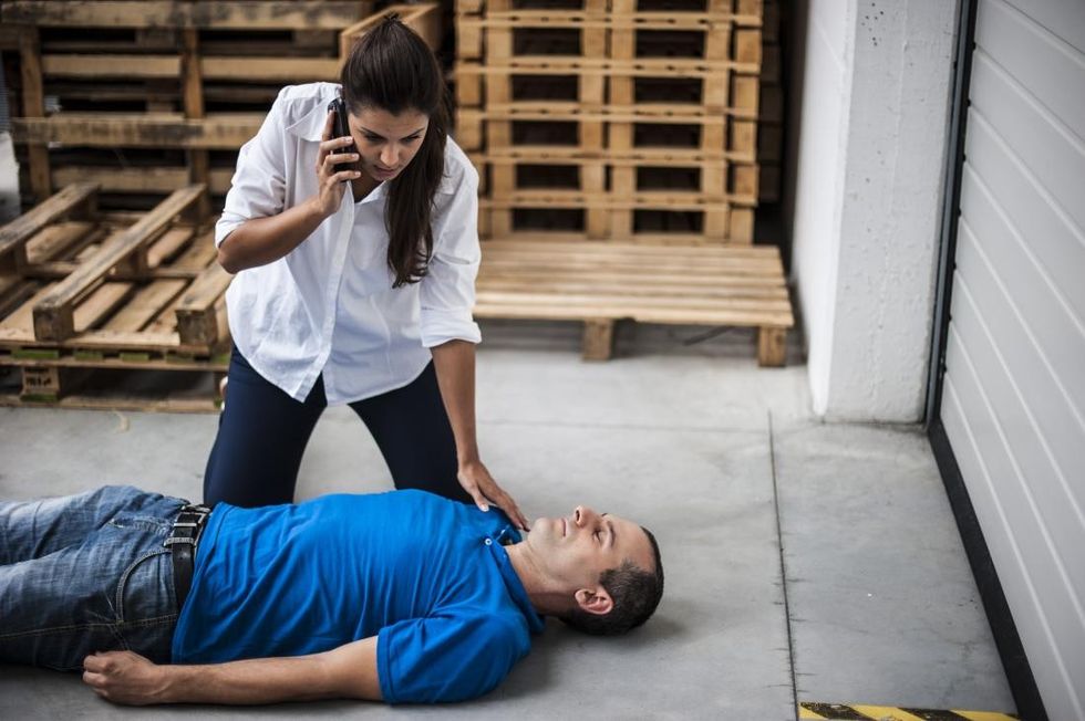 woman with unconscious man calling 9