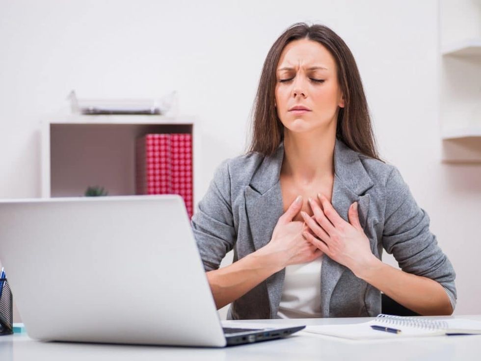 woman worker stess chest pain large bigstock