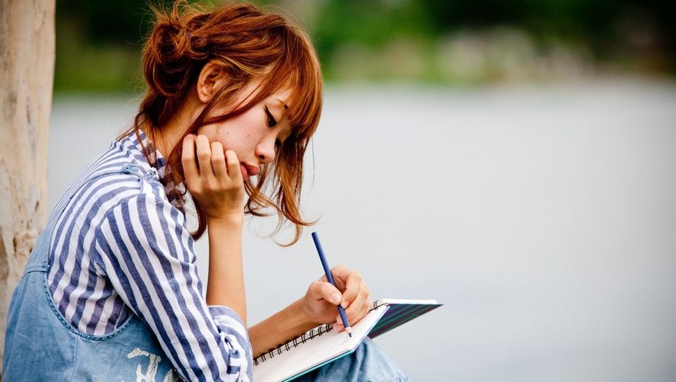 woman-writing-letter-park