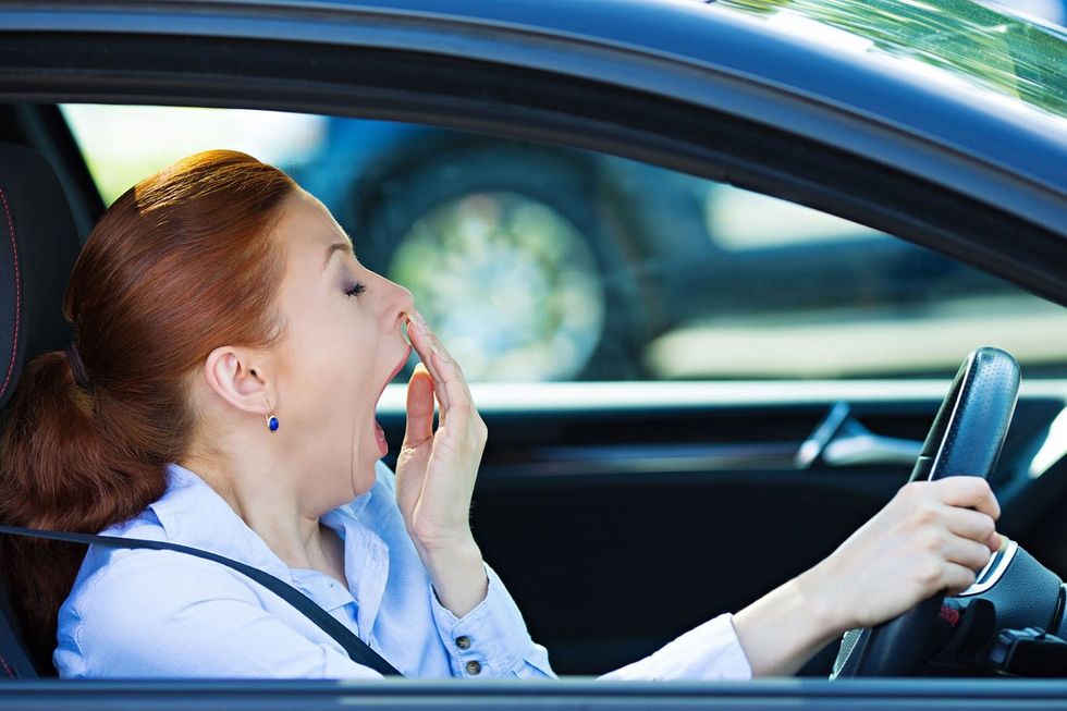 woman yawning in car 29416449 l