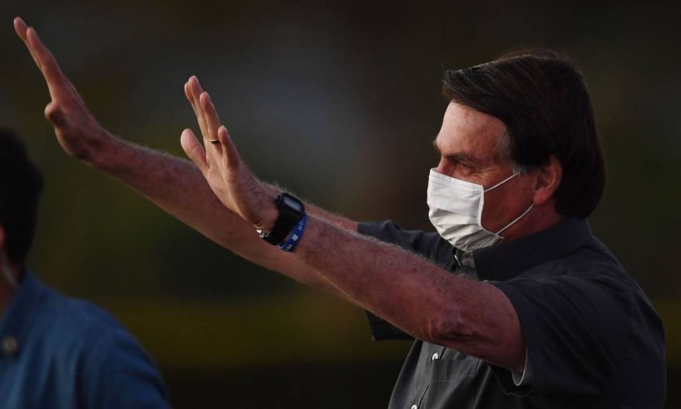 x88887228 Brazilian President Jair Bolsonaro waves to supporters from the Alvorada Palace in Bras.pagespeed.ic .iaaXu1zBZp