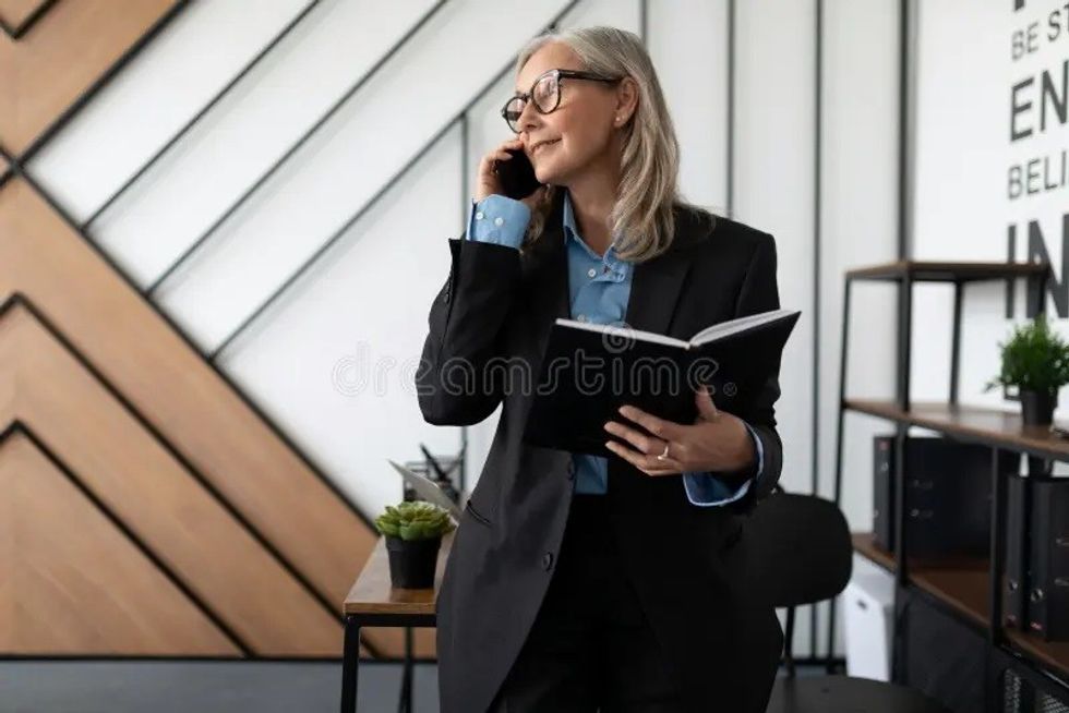 year old lawyer woman talking mobile phone office year