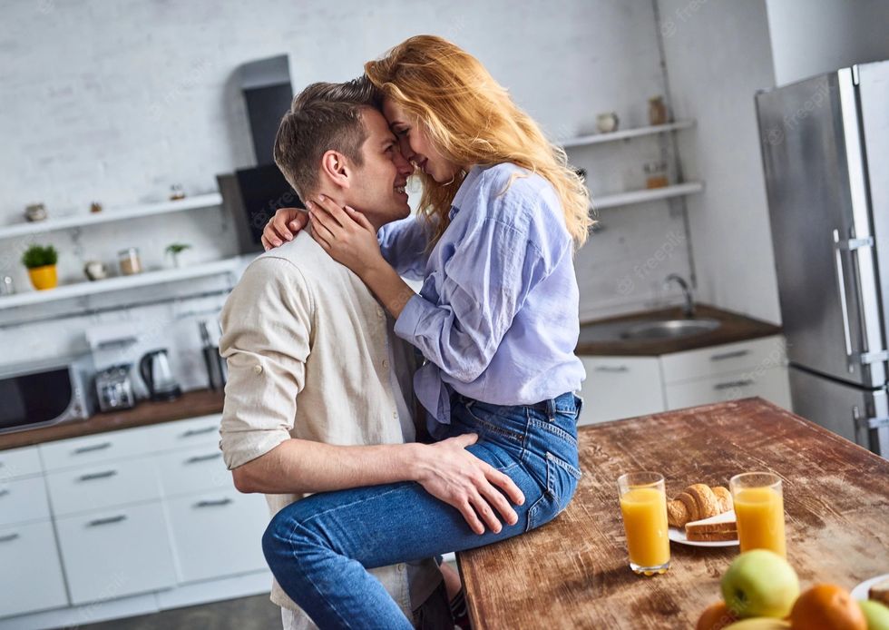 young couple love kitchen attractive girl sitting table guy hugs her romantic breakfast 497171 626