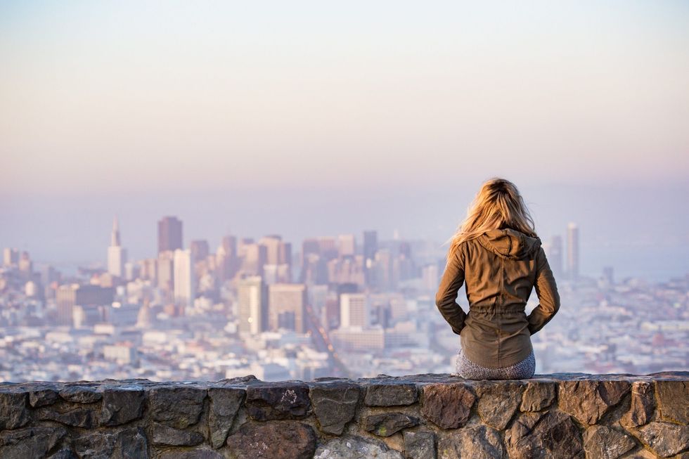 young girl enjoying moment and looking over the city of san francisco picjumbo com scaled