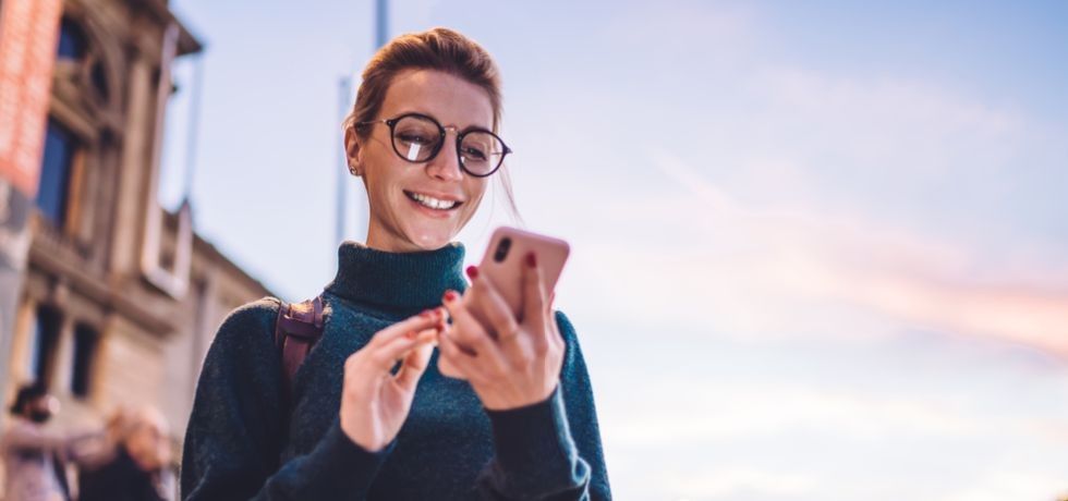 young hipster woman reading text message