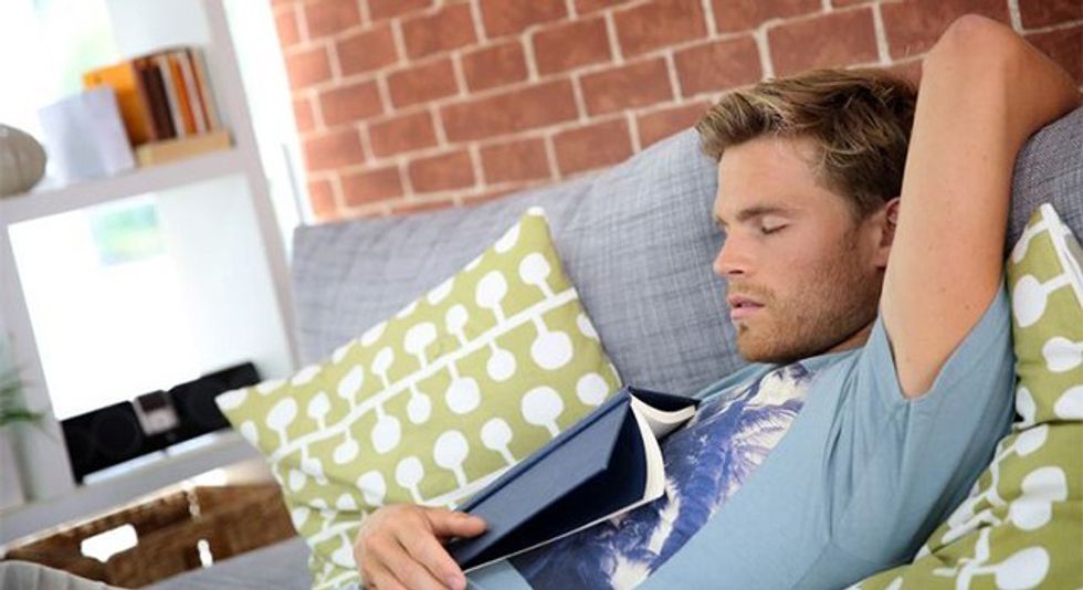 Young man at home taking a nap in sofa