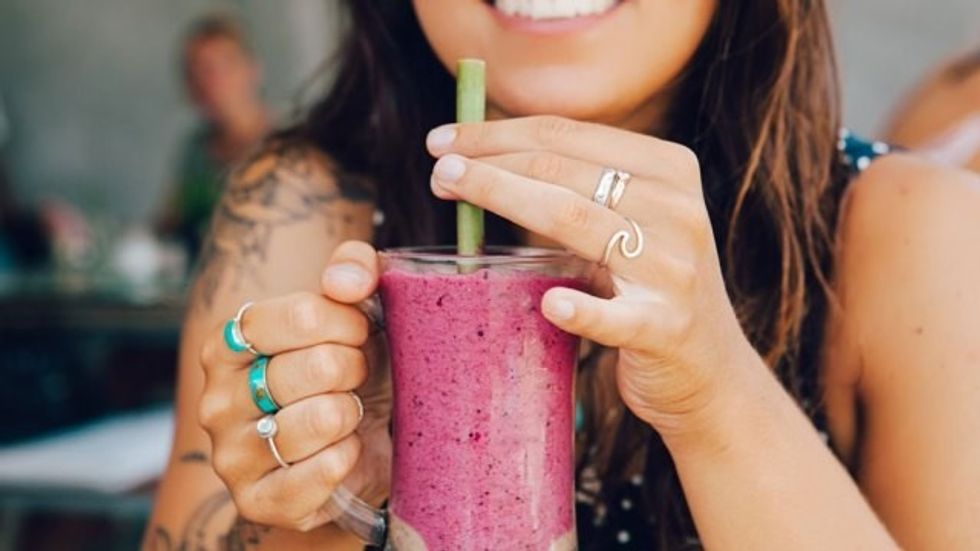 young woman drinking smoothie
