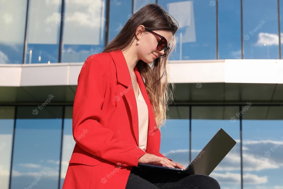 young woman is working laptop outside office summer day remote work 307890 7367