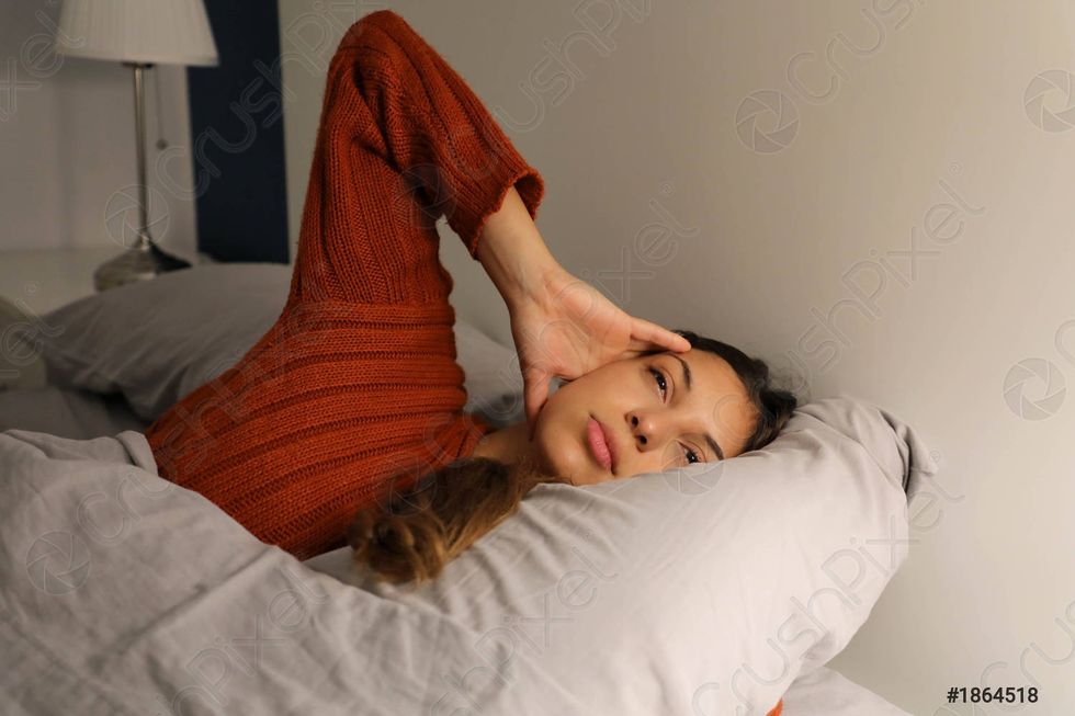 young woman on bed suffering 1864518