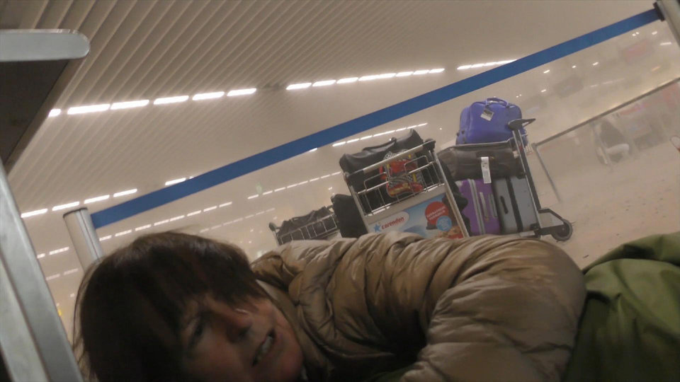 In this photo provided by Ralph Usbeck an unidentified traveller lies on the ground in a smoke filled terminal at Brussels Airport, in Brussels, after explosions Tuesday, March 22, 2016. Authorities locked down the Belgian capital on Tuesday after explosions rocked the Brussels airport and subway system, killing  a number of people and injuring many more. Belgium raised its terror alert to its highest level, diverting arriving planes and trains and ordering people to stay where they were. Airports across Europe tightened security.  (Ralph Usbeck via AP)