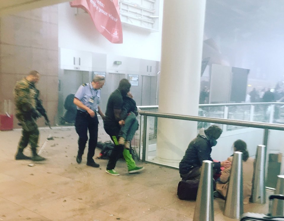 This photo provided by Georgian Public Broadcaster and photographed by Ketevan Kardava, shows the scene in Brussels Airport in Brussels, Belgium, after explosions were heard Tuesday, March 22, 2016. A developing situation left a number dead in explosions that ripped through the departure hall at Brussels airport Tuesday, police said. All flights were canceled, arriving planes were being diverted and Belgium's terror alert level was raised to maximum, officials said. (Ketevan Kardava/ Georgian Public Broadcaster via AP)