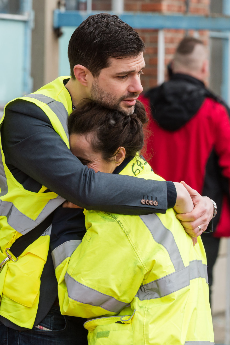 People react outside Brussels airport after explosions rocked the facility in Brussels, Belgium Tuesday March 22, 2016.   Explosions rocked the Brussels airport and the subway system Tuesday, just days after the main suspect in the November Paris attacks was arrested in the city, police said. (AP Photo/Geert Vanden Wijngaert)