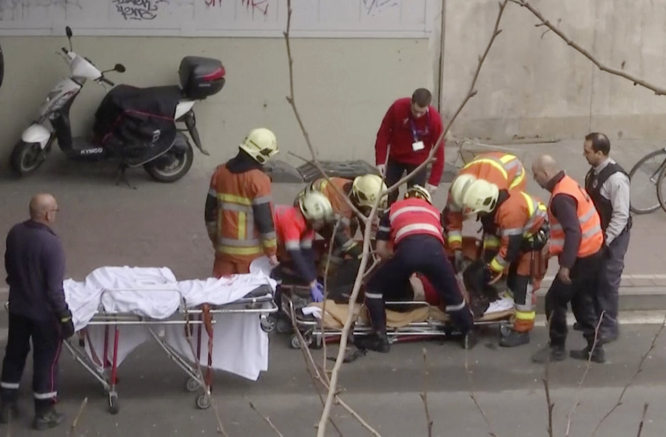 In this image made from video, emergency rescue workers stretcher an unidentified person at the site of an explosion at a metro station in Brussels, Belgium, March 22, 2016.   Explosions rocked the Brussels airport and the subway system Tuesday, just days after the main suspect in the November Paris attacks was arrested in the city, police said.(APTN via AP)