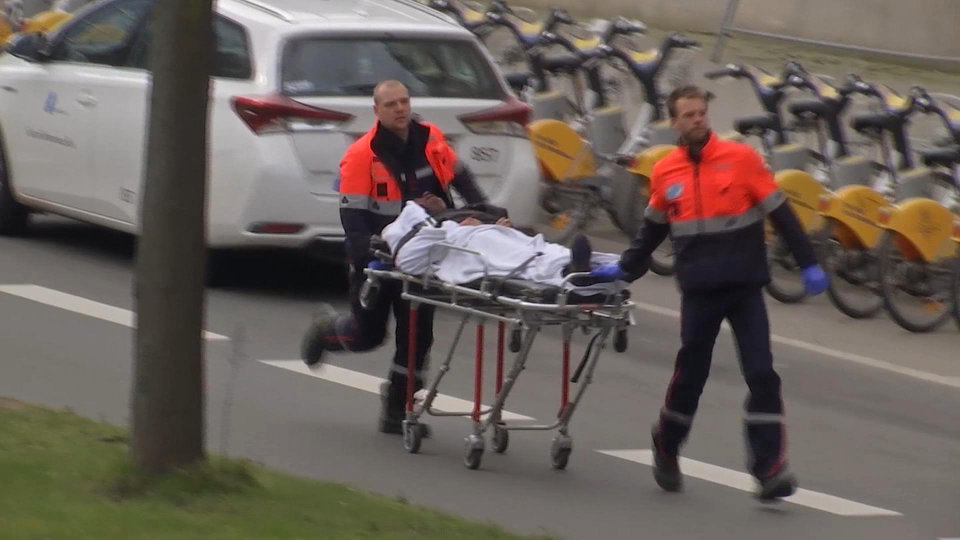 In this image taken from TV an injured person is evacuated as emergency services attend the scene after an explosion in a main metro station in Brussels on Tuesday, March 22, 2016. Explosions rocked the Brussels airport and the subway system Tuesday, killing a number of  people and injuring many others just days after the main suspect in the November Paris attacks was arrested in the city, police said. (AP Photo)