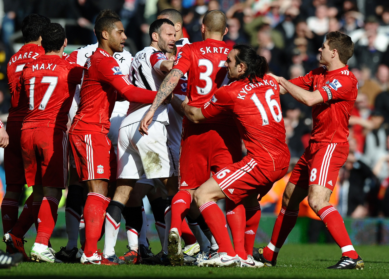 Players from both teams clash after Manchester United's Brazilian defender Rafael Da Silva's foul on Liverpool's Brazilian midfielder Lucas Leiva during the English Premier League football match between Liverpool and Manchester United at Anfield, Liverpool, northwest England, on March 6, 2011.AFP PHOTO/ PAUL ELLIS --- RESTRICTED TO EDITORIAL USE Additional licence required for any commercial/promotional use or use on TV or internet (except identical online version of newspaper) of Premier League/Football League photos. Tel DataCo +44 207 2981656. Do not alter/modify photo (Photo credit should read PAUL ELLIS/AFP/Getty Images)