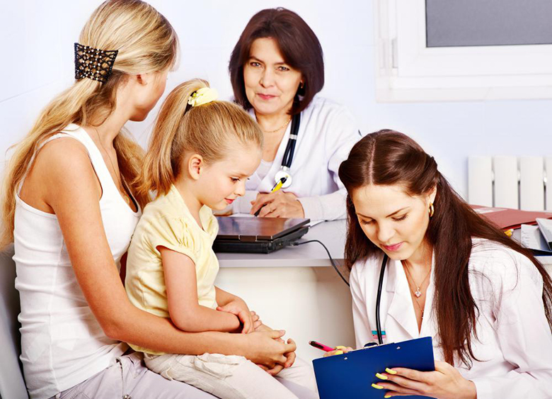 doctors-near-woman-with-child-in-lap