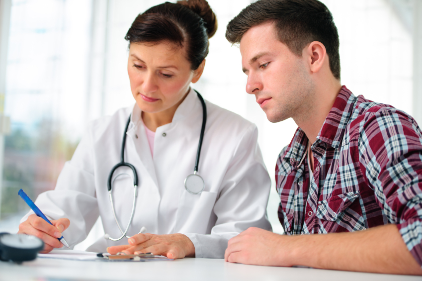 Doctor talking to her male patient at office