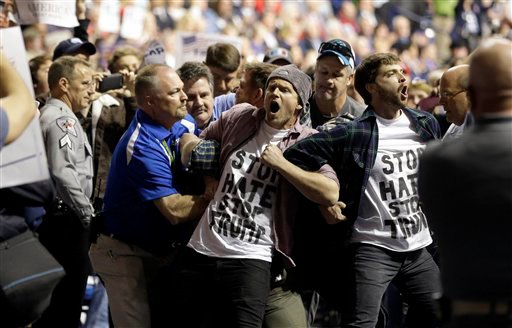 Protesters are removed as Republican presidential candidate Donald Trump speaks during a campaign rally in Fayetteville, N.C., Wednesday, March 9, 2016. (AP Photo/Gerry Broome)