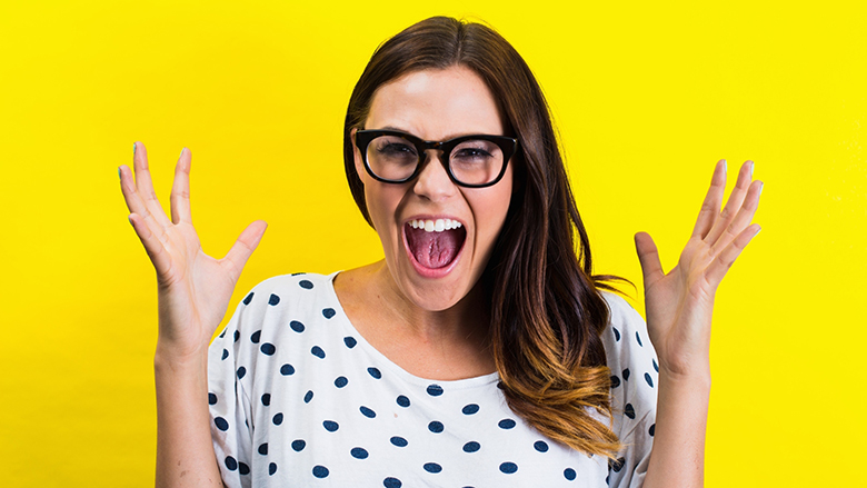 Portrait of young woman with eyeglasses, screaming
