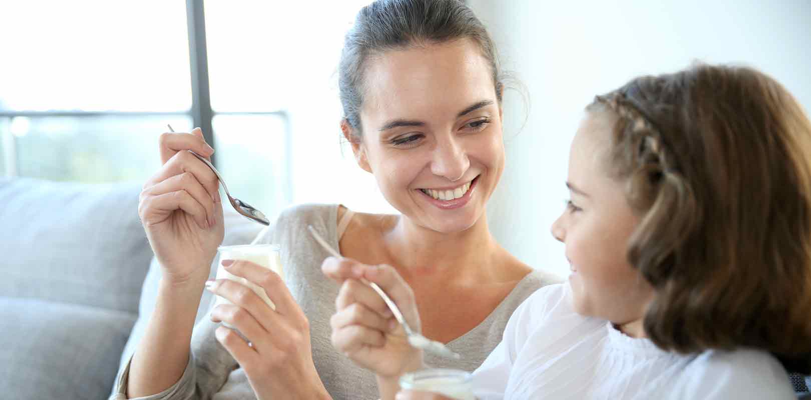 Mother-and-daughter-eating-yoghurt