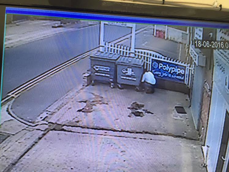 A traffic warden has been caught on CCTV hiding behind bins in a bid to issue tickets to unsuspecting shoppers on a busy retail park in Wincheap, Canterbury, in Kent. This still is from Darren Clark's CCTV, who owns Canterbury Plumbing Supplies. He found the warden crouched down behind bins. Picture from Ferrari Press Agency