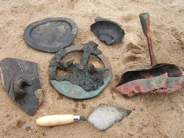 A selection of items from the ship with a trowel below them for scale. The best preserved astrolabe is in the middle, a nice frying pan on the right, some pottery on left, a pewter plate above and a section of a pewter porridge bowel is on the top right. Picture: Dieter Noli Source: Dieter Noli