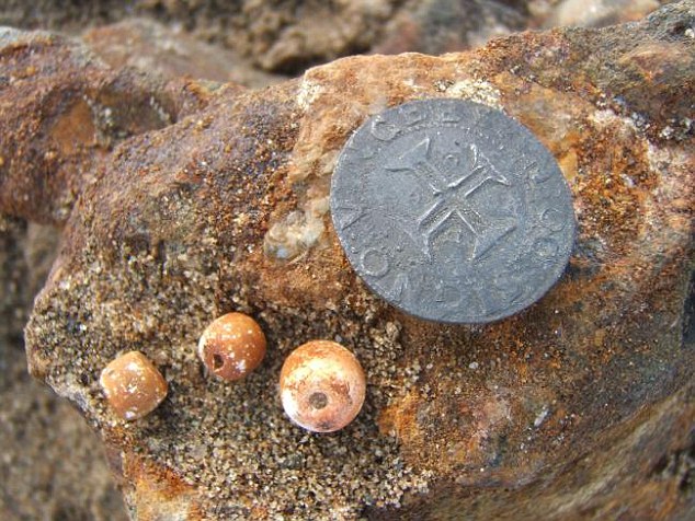 Some rosary beads and a silver Portuguese coin. Picture: Dieter Noli Source: Dieter Noli