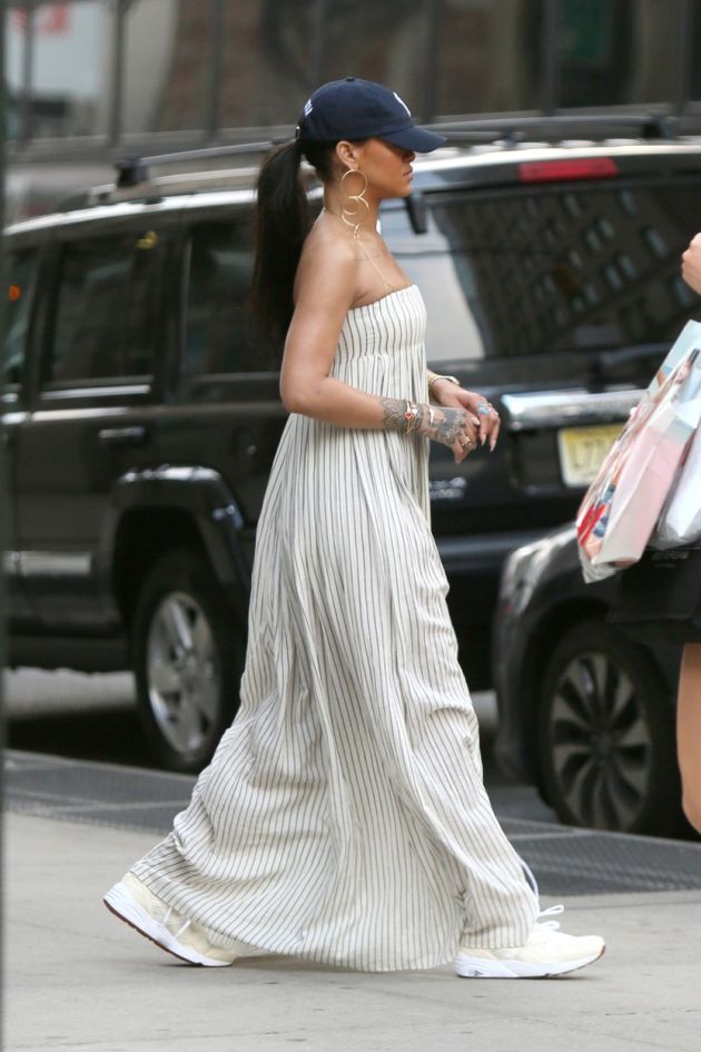 New York, NY - Singer Rihanna and her entourage seen exiting her apt. building in Manhattan as they head out to Queens for a photo shoot. RiRi wore a pin striped maxi strapless dress with a navy blue cap and pale yellow sneakers. May 27, 2016, Image: 287260087, License: Rights-managed, Restrictions: NO Brazil, Model Release: no, Credit line: Profimedia, AKM-GSI