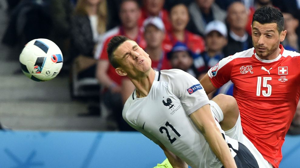 France's defender Laurent Koscielny (L) heads the ball next to Switzerland's midfielder Blerim Dzemaili during the Euro 2016 group A football match between Switzerland and France at the Pierre-Mauroy stadium in Lille on June 19, 2016. / AFP / PHILIPPE HUGUEN (Photo credit should read PHILIPPE HUGUEN/AFP/Getty Images)