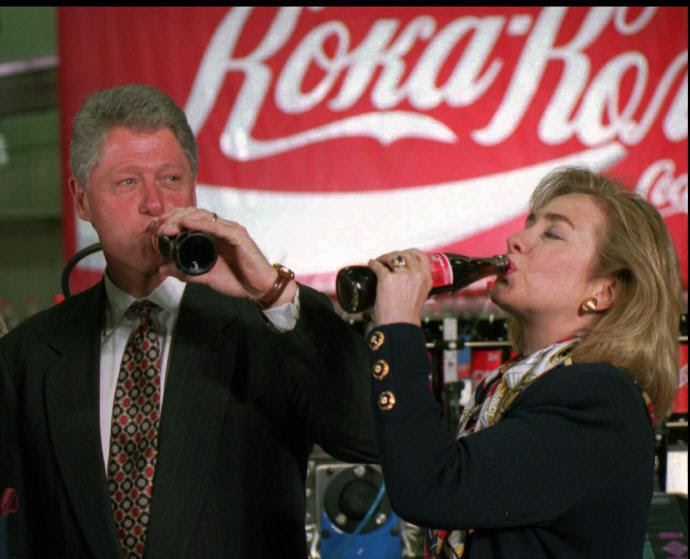95 U.S. President Bill Clinton and Hillary Rodham Clinton drink Coca-Cola at Moscow's Coca-Cola refreshments plant Thursday, May 11, 1995. The sign in the background reads Coca-Cola in Russian. (AP PHOTO/Greg Gibson)