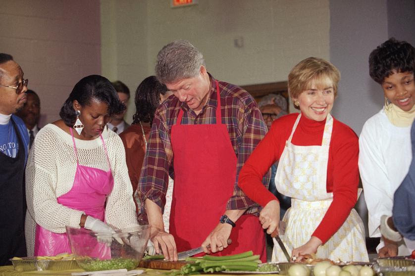 93 President Bill Clinton and first lady Hillary Rodham Clinton is joined by Comiller Bronson in cutting vegetables at the Covenant Baptist Church in Washington, Nov. 24, 1993. The president and first lady were helping the church prepare for their Thanksgiving Day dinner. (AP Photo/Doug Mills)