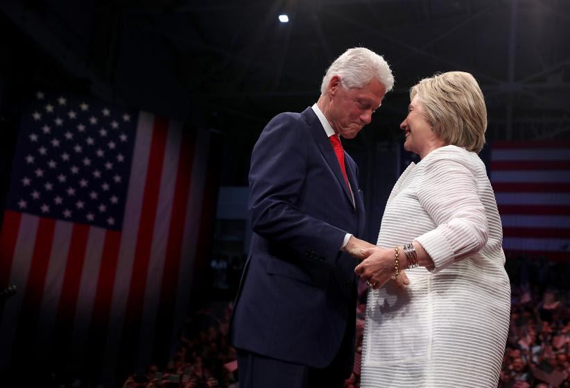 2016 BROOKLYN, NY - JUNE 07:  Democratic presidential candidate former Secretary of State Hillary Clinton (R) and her husband former U.S. president Bill Clinton embrace during a primary night event on June 7, 2016 in Brooklyn, New York. Hillary Clinton surpassed the number of delegates needed to become the democratic nominee over rival Bernie Sanders with a win in the New Jersey presidential primary  (Photo by Justin Sullivan/Getty Images)