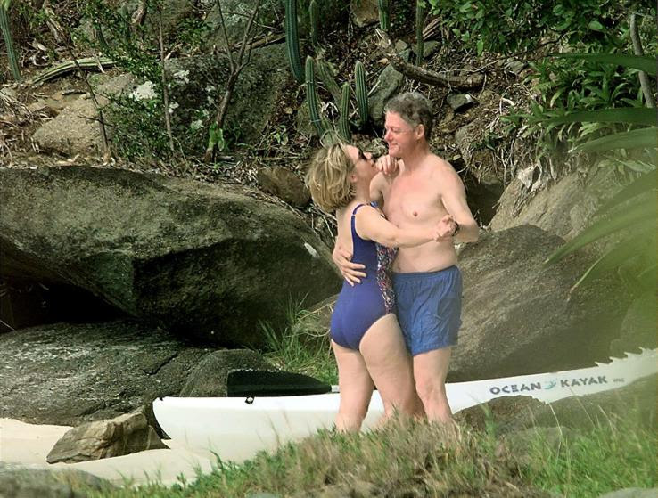 98 ST. THOMAS, UNITED STATES:  File photo dated 04 January 1998 shows US President Bill Clinton and First Lady Hillary Clinton dancing on the beach of Megan Bay, St. Thomas, US Virgin Islands shortly after taking a swim. A poll of New York voters released 05 June 2003 finds them divided on the issue of why the former First Lady Hillary Clinton penned her soon-to-be released memoirs. Twenty-eight percent said the book was meant to lay groundwork for a future presidential run, while 27 percent believe her main motivation was to "tell her side of the story."   AFP PHOTO/PAUL J. RICHARDS (Photo credit should read PAUL J. RICHARDS/AFP/Getty Images)
