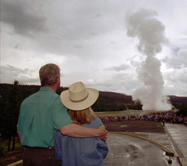 95 President Clinton puts an arm around his wife, Hillary, while watching Old Faithful erupt at Yellowstone National Park, Wyo., Friday, Aug. 25, 1995. The first family visited several Yellowstone sites while on vacation.  (AP Photo/Doug Mills)