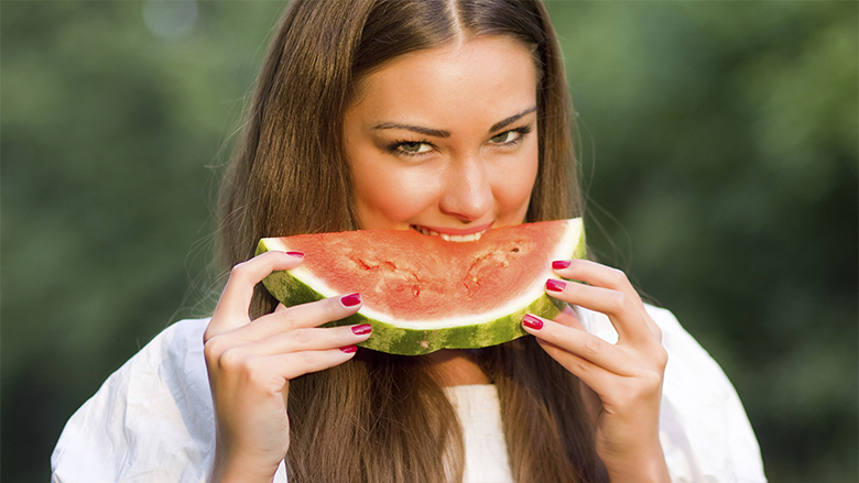 Pretty woman eating water-melon outdoor