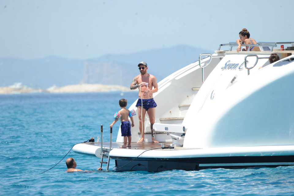 Lionel Messi looks relaxed as he enjoys his holiday - just after being handed a jail term for tax fraud. The Barcelona and Argentina ace - sporting a bushy beard - relaxed for the second day in a row on holiday in Ibiza, Spain with his family. He was with long-term partner Antonella Roccuzzo and the couple's two young sons, Thiago and Mateo as well as several pals aboard a luxury yacht, and was seen showering himself off. Messi, 29, was last week sentenced in Spain to 21 months in prison for tax fraud. His father, Jorge Messi, was also given a jail term. But neither man is expected to serve time behind bars. The Spanish legal system means prison terms of under two years are often served under probation. Pictured: Lionel Messi and family Ref: SPL1316695 120716 Picture by: Silvia & Sergio / Splash News Splash News and Pictures Los Angeles: 310-821-2666 New York: 212-619-2666 London: 870-934-2666 photodesk@splashnews.com