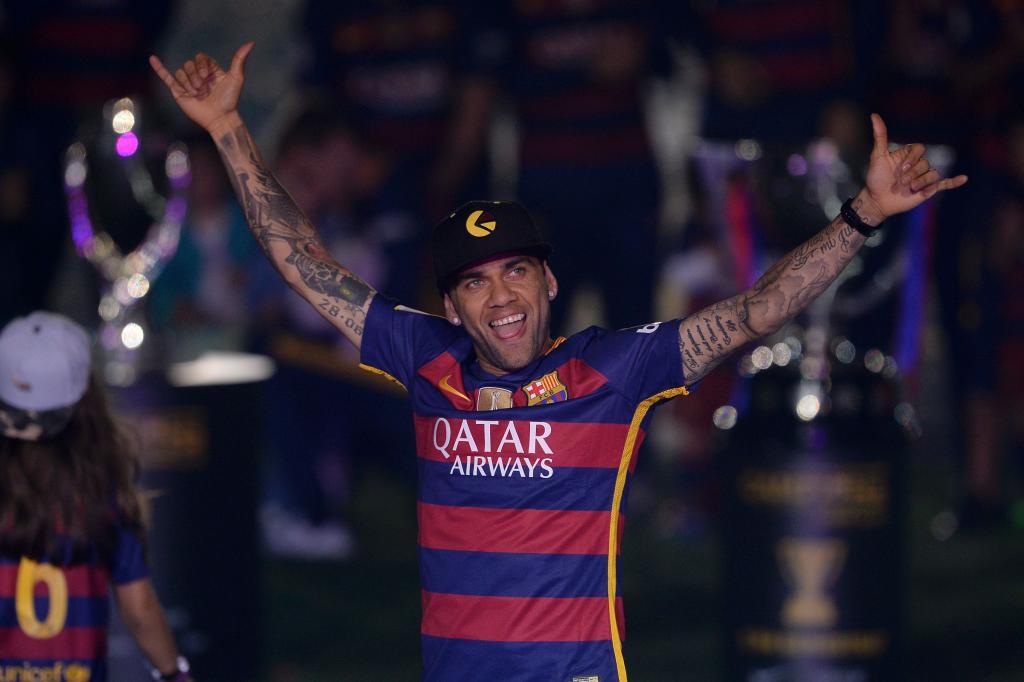 Barcelona's Brazilian defender Dani Alves acknowledges the crowd during celebrations at the Camp Nou stadium in Barcelona on May 23, 2016 following their Spanish "Copa del Rey" (King's Cup) final football match 2-0 victory over Sevilla FC yesterday also marking the club's 28th Copa del Rey win and the 24th Spanish Liga title. / AFP PHOTO / JOSEP LAGO