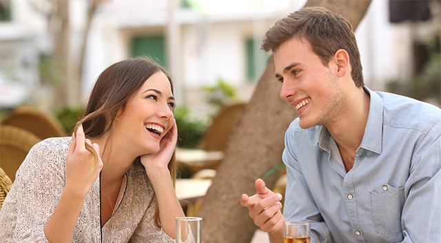 Couple dating and flirting while taking a conversation and looking each other in a restaurant