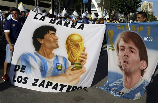 Argentinian fans hold banners with portraits of soccer legend Diego Armando Maradona, left, and Barcelona's soccer star Lionel Messi before the group F World Cup soccer match between Argentina and Bosnia in Rio de Janeiro, Brazil, Sunday, June 15, 2014. (AP Photo/Thanassis Stavrakis)
