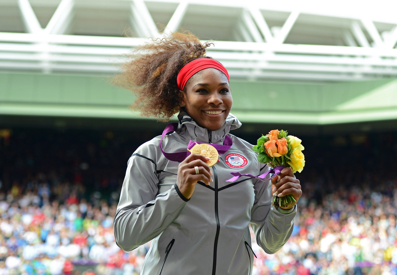 Aug 4, 2012; London, United Kingdom; Serena Williams (USA) holds the gold medal as she celebrates after defeating Maria Sharapova (not pictured) during the London 2012 Olympic Games at Wimbledon. Mandatory Credit: Mark J. Rebilas-USA TODAY Sports