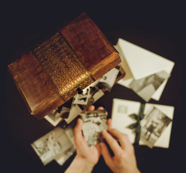 Hands of man holding old photographs