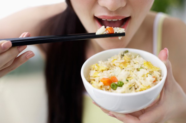 Young Woman Eating Rice Dish