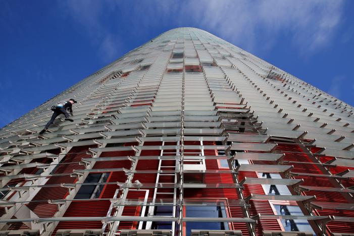 French climber Alain Robert, also known as "The French Spiderman", scales the 38-story skyscraper Torre Agbar in Barcelona