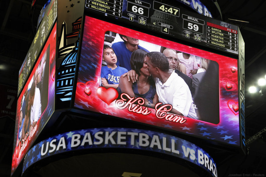 U.S. President Obama and first lady Michelle Obama are shown kissing on the "Kiss Cam" screen during a timeout in the Olympic basketball exhibition game between the U.S. and Brazil national men's teams in Washington