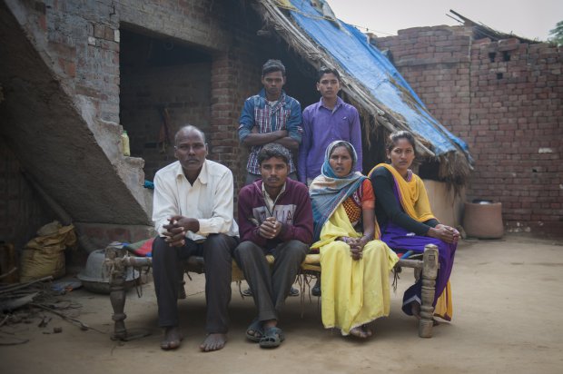 *** EXCLUSIVE - VIDEO AVAILABLE *** FARRUKHABAD, INDIA - DECEMBER 09: Arun Kumar Rajput sits with his father Sri Ram Singh, 55 years (left), mother Kokla Devi , 50 years (right), his sister Aarti (extreme right) and his two brothers Lal Bahadur (back left) and Sudeer Rajput (back right) at his house on December 09, 2015 in Farrukhabad, India. A YOUNG man with FOUR legs appealed to doctors to amputate his two extra limbs. Arun Kumar, 22, was born with two extra legs growing from his lower back - one underdeveloped and the other permanently bent at the knee. After living for 15 years without any kind of treatment, Arun, from Uttar Pradesh, India, appealed through social media for medical help to remove his extra legs. A team of specialists at Fortis Hospital in Delhi responded to Arunís plea for help and organised a series of tests to find out how the legs are attached and if he can be treated. **CONDITION OF USAGE: The following plug must be used in print and/or online: Arun's story appears in Body Bizarre, Thursday November 3, 10pm, on TLCî credit: TLC/ Barcroft Productions** PHOTOGRAPH BY Arkaprava Ghosh / Barcroft Images London-T:+44 207 033 1031 E:hello@barcroftmedia.com New York-T:+1 212 796 2458 E:hello@barcroftusa.com New Delhi-T:+91 11 4053 2429 E:hello@barcroftindia.com www.barcroftimages.com