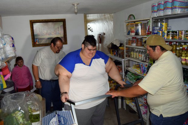 Juan Pedro, 32, leaves his home as he walks toward an ambulance before being transported to a hospital in Guadalajara, to undergo treatment in order to shed excess from his 500-kilo weight, in Aguascalientes, Mexico, November 15, 2016. Picture taken November 15, 2016. REUTERS/Liberto Urena FOR EDITORIAL USE ONLY. NO RESALES. NO ARCHIVES.