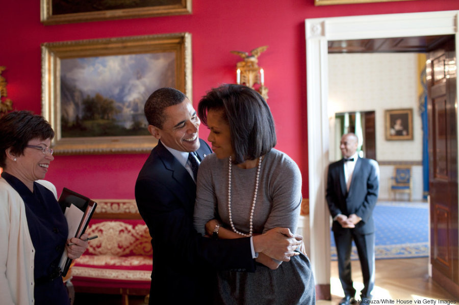 WASHINGTON - MARCH 20: In this handout provide by the White House, U.S. President Barack Obama (R) hugs First Lady Michelle Obama in the Red Room while Senior Advisor Valerie Jarrett (L) smiles prior to the National Newspaper Publishers Association (NNPA) at the White House on March 20, 2009 in Washington, DC. Obama is serving as the 44th President of the U.S. and the first African-American to be elected to the office of President in the history of the United States. (Photo by Pete Souza/White House via Getty Images)